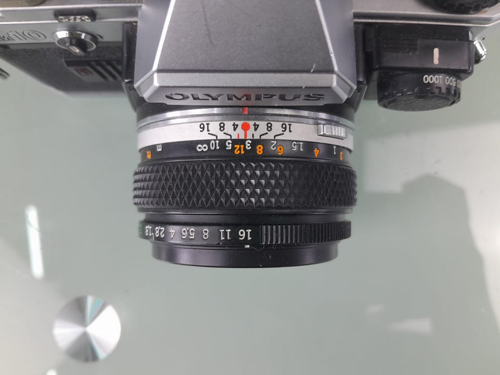 OLYMPUS OM 10 SLR CAMERA WITH ZUIKO MC AUTO-S 1:1.8 F=50MM LENS